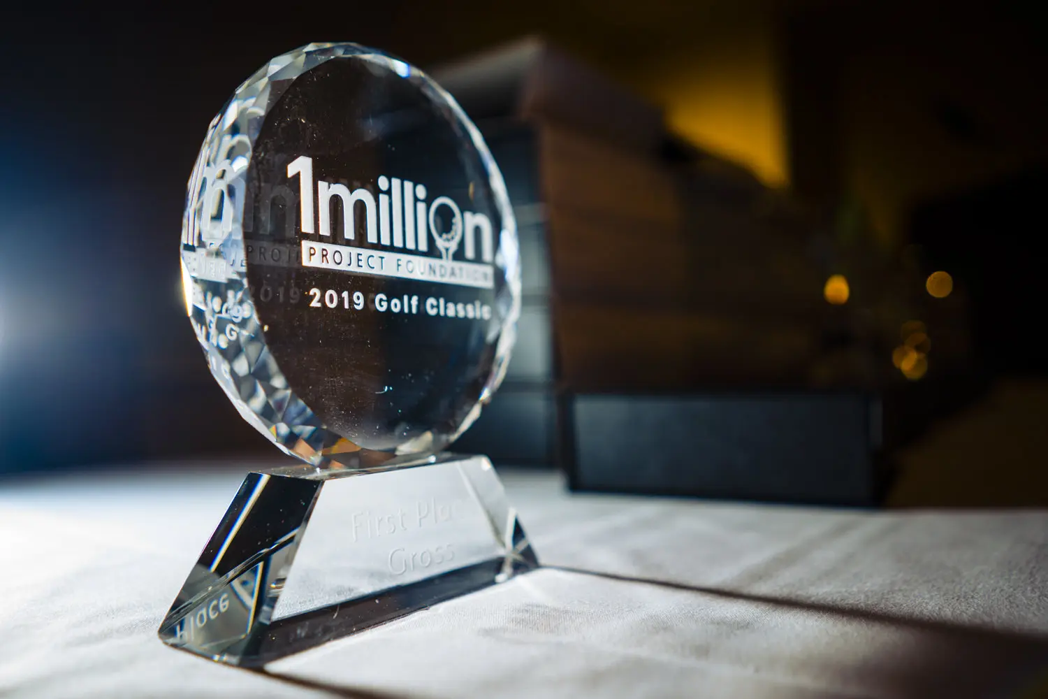 A detailed, close-up picture of a crystal award for the 1 million project golf tournament.